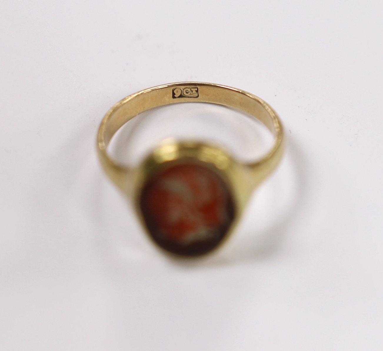 An antique 9ct and intaglio glass? set oval ring, depicting the bust of a Roman soldier to dexter, size P, gross weight 3.8 grams.